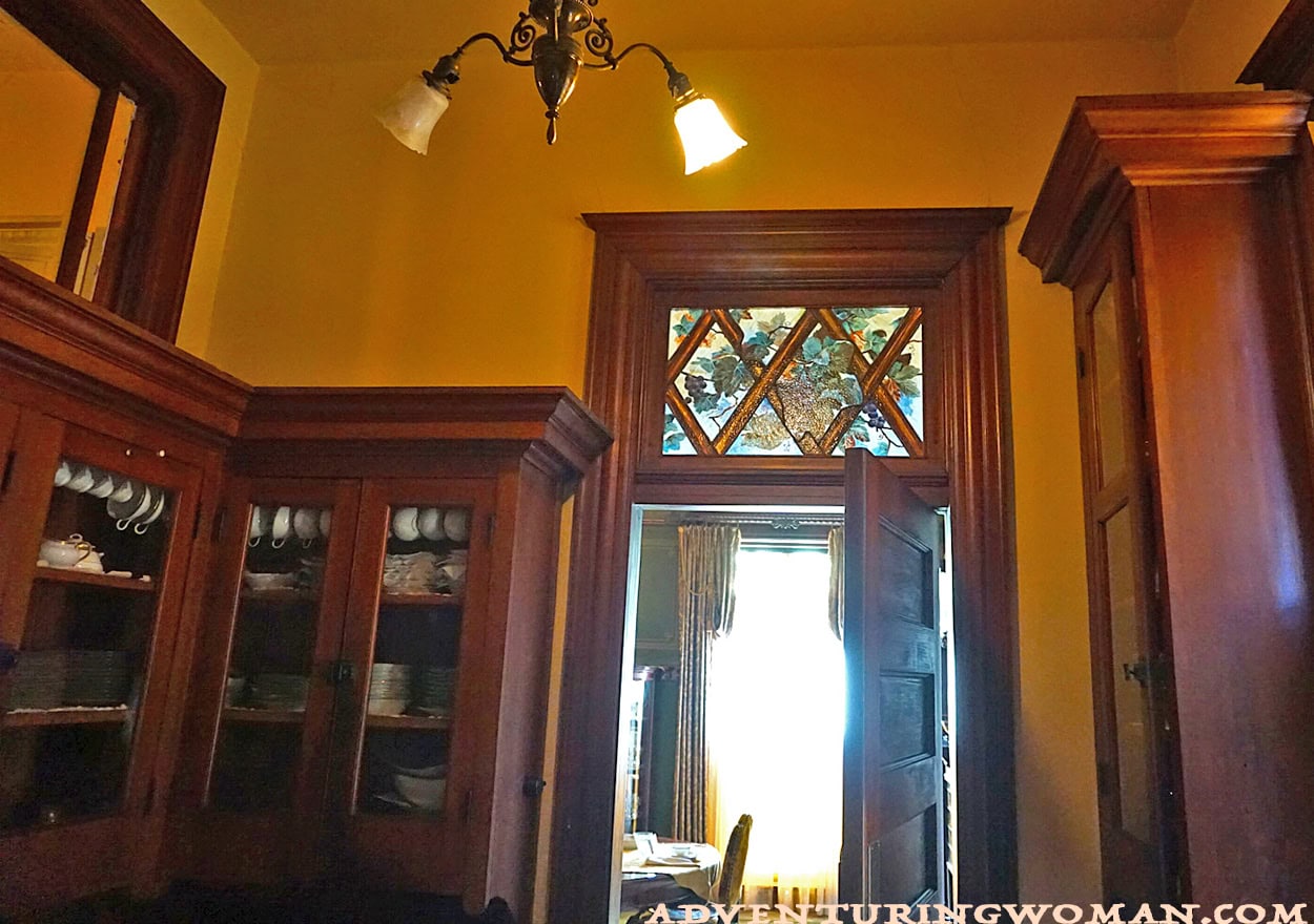 The butler's pantry in the Overholser Mansion in Oklahoma City, showing the door to the dining room with a beautiful stained glass transom