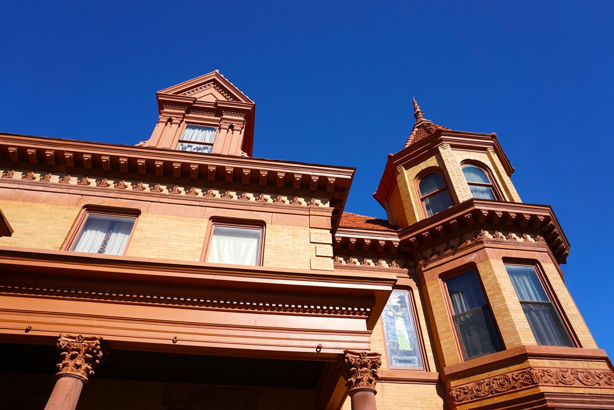 The Overholser mansion's architectural style, Chateauesque, is patterned after the designs of monumental French chateaus of the 16th century. The style is unusual, especially in the Midwest. It is characterized by steeply pitched roofs and decorative gabled dormers, towers or turrets, and tall chimneys with decorative caps.