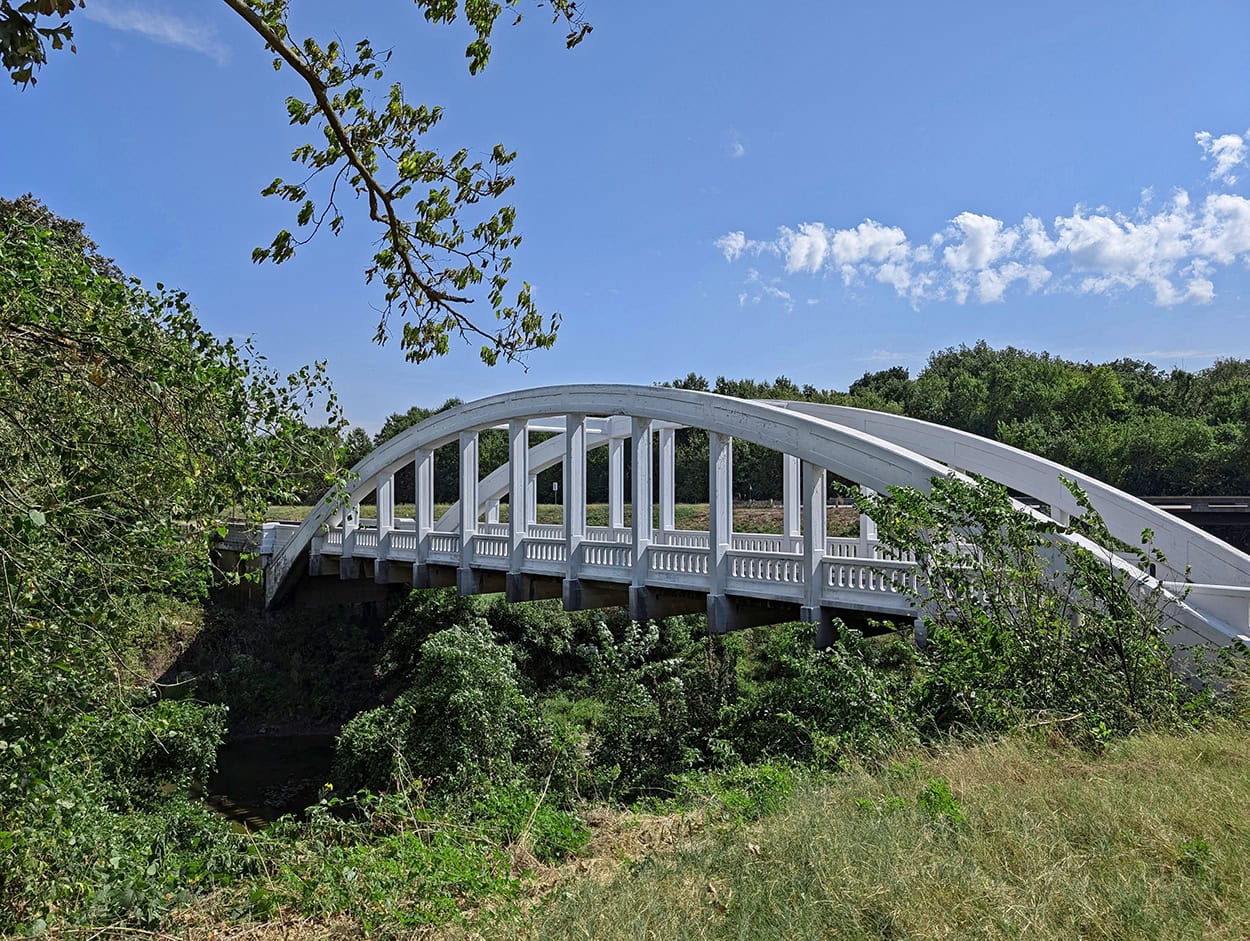 The Marsh Rainbow Arch Bridge at Brush Creek is the last bridge of its kind on Historic US Route 66. It's located near Baxter Springs, Kansas.